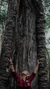 A Woman Standing Near the Tree Trunk