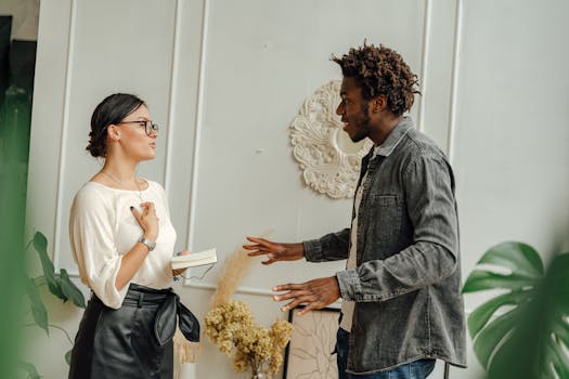 Man in Gray Dress Shirt Holding Woman in White Dress